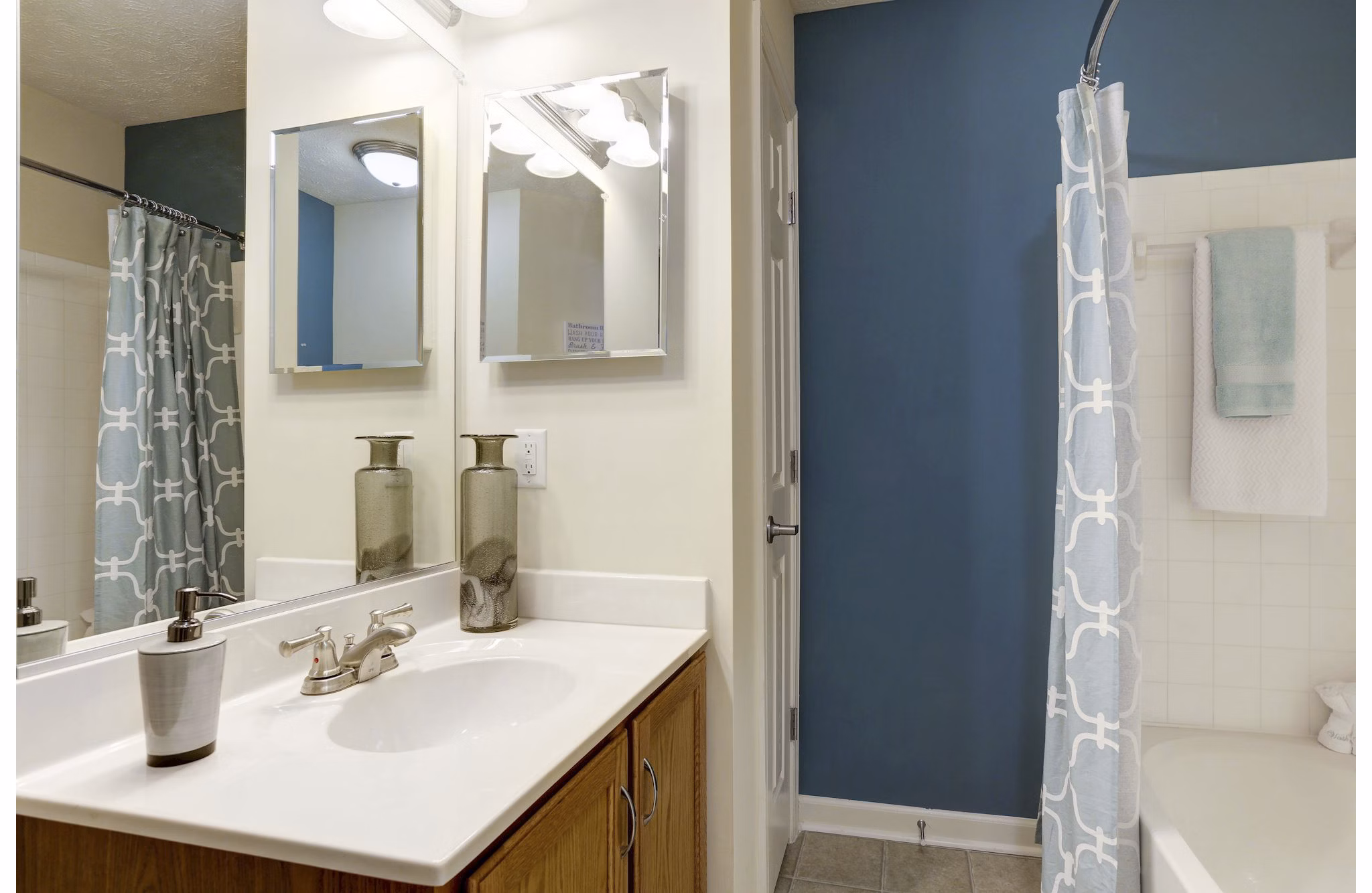 Modern bathroom featuring sleek fixtures and marble countertop in Kaiser Park Apartments