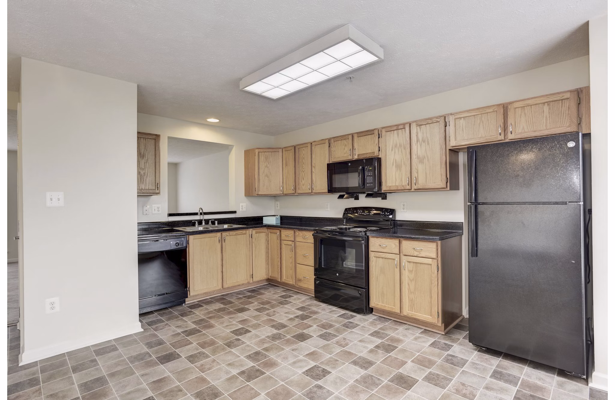 Kitchen featuring modern appliances and granite countertops in Kaiser Park Apartments luxury homes