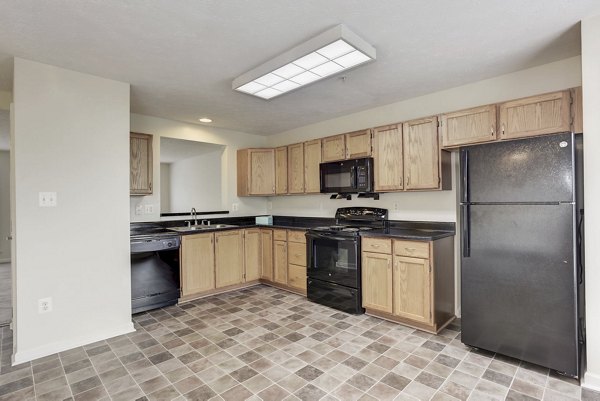 Kitchen featuring modern appliances and granite countertops in Kaiser Park Apartments luxury homes
