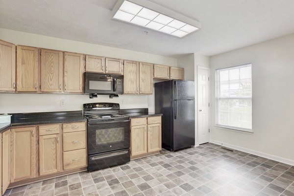 Modern kitchen with stainless steel appliances at Kaiser Park Apartments, luxury living space designed for style and functionality