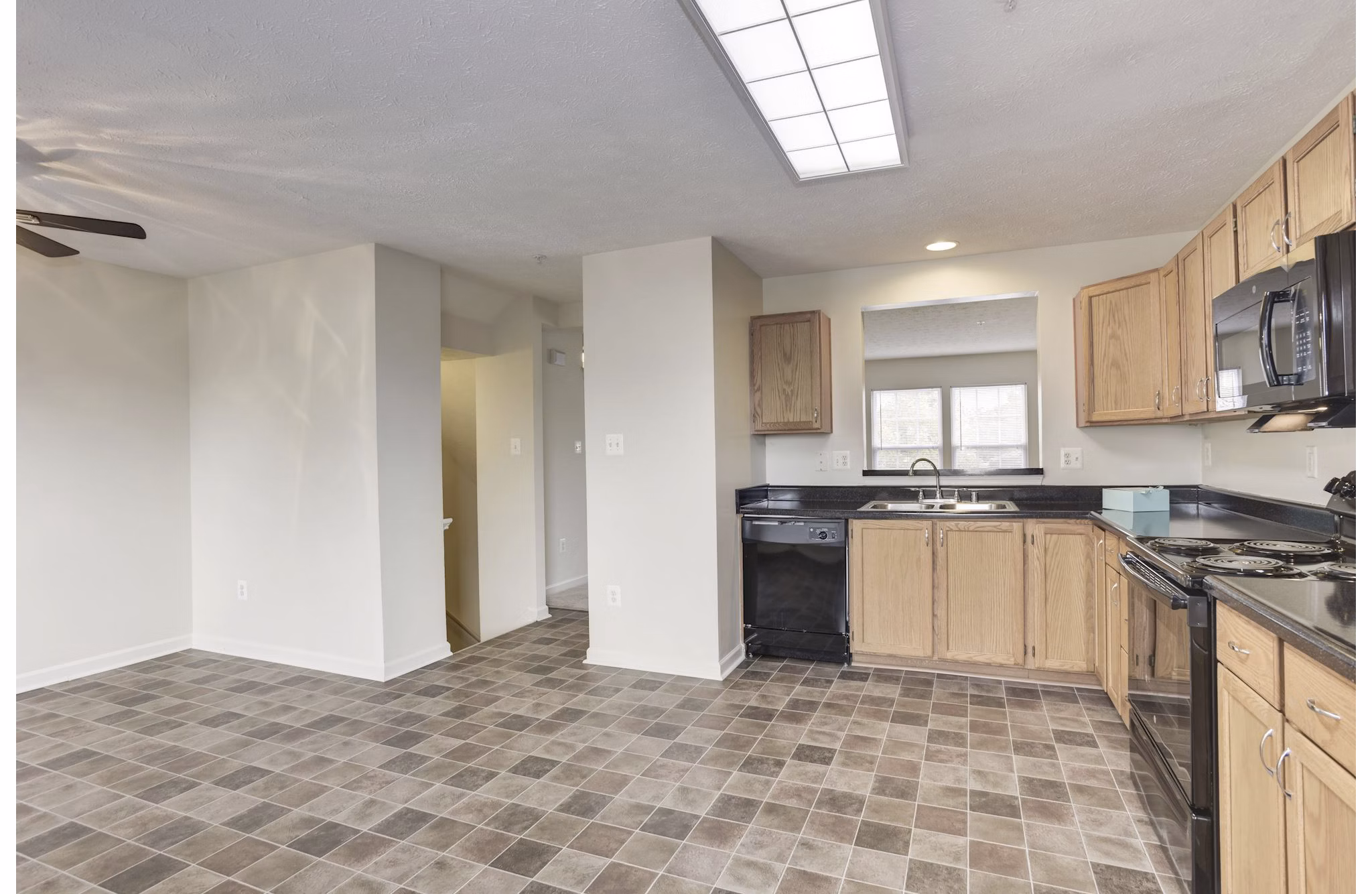 Modern kitchen with stainless steel appliances and granite countertops in Kaiser Park Apartments, Greystar luxury properties