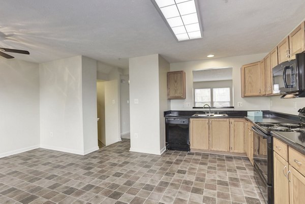 Modern kitchen with stainless steel appliances and granite countertops in Kaiser Park Apartments, Greystar luxury properties