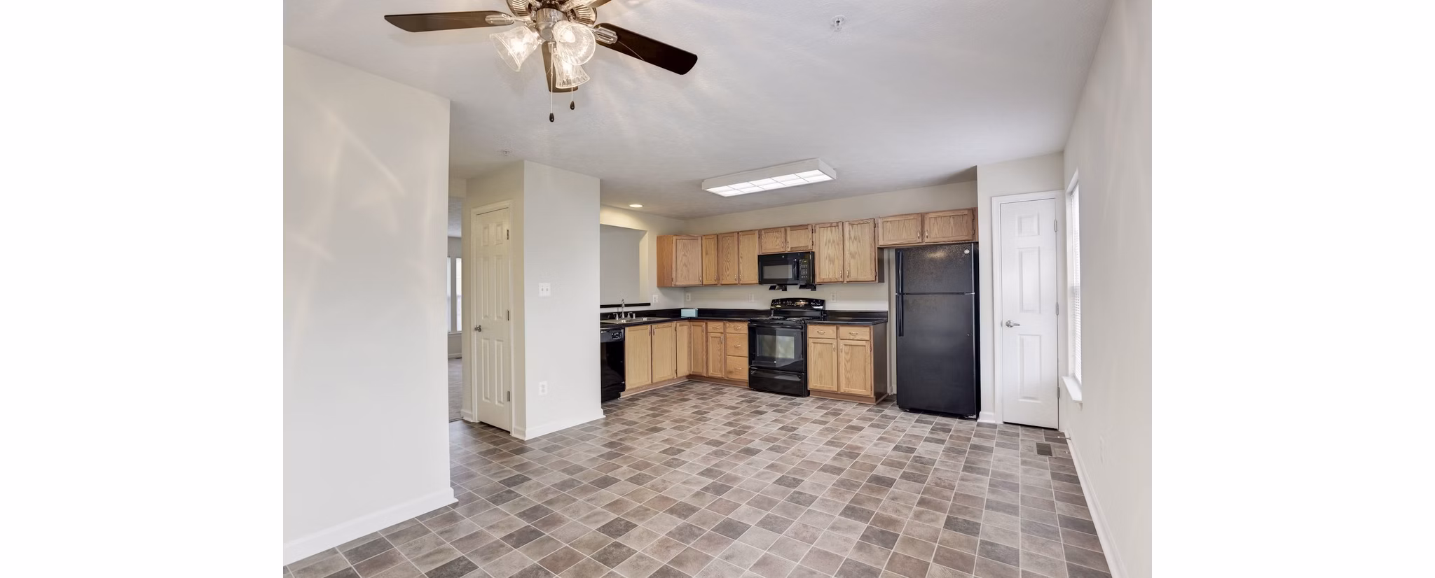 Kaiser Park Apartments: Modern kitchen with stainless steel appliances and quartz countertops in contemporary luxury apartments