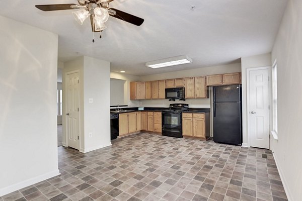Kaiser Park Apartments: Modern kitchen with stainless steel appliances and quartz countertops in contemporary luxury apartments