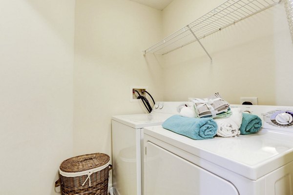 Laundry room with energy-efficient machines at Kaiser Park Apartments