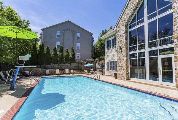 Relaxing poolside setting at Kaiser Park Apartments with lounge chairs and scenic views