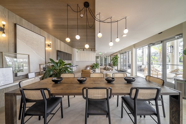 Clubhouse featuring modern decor and ample seating at Novel Nona Apartments