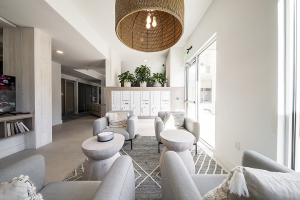 Clubhouse with modern furnishings at Novel Nona Apartments featuring luxury living spaces for relaxation and socializing