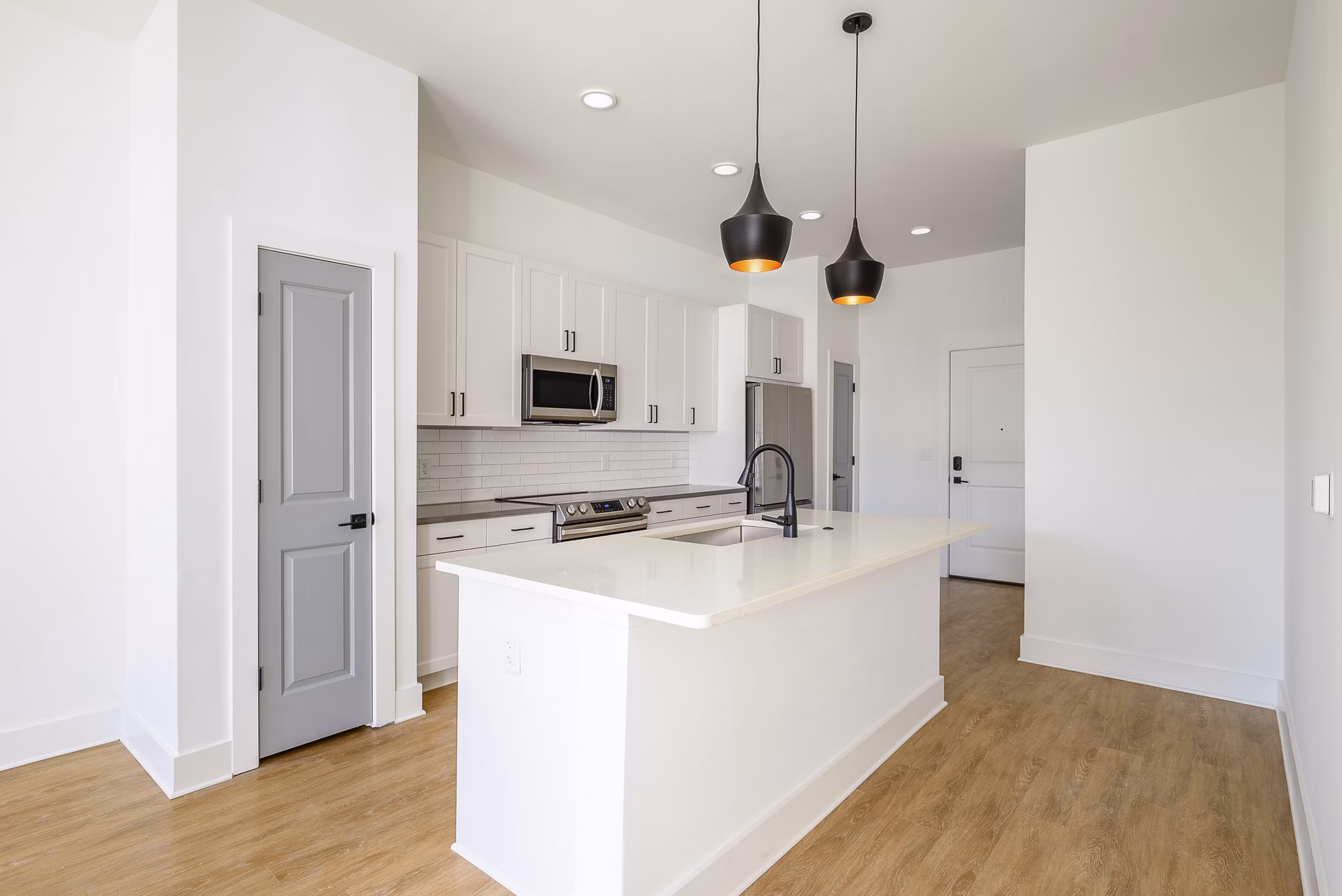 Modern kitchen featuring stainless steel appliances and granite countertops in Novel Nona Apartments, luxury living in Orlando