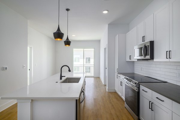 Modern kitchen with stainless steel appliances at Novel Nona Apartments