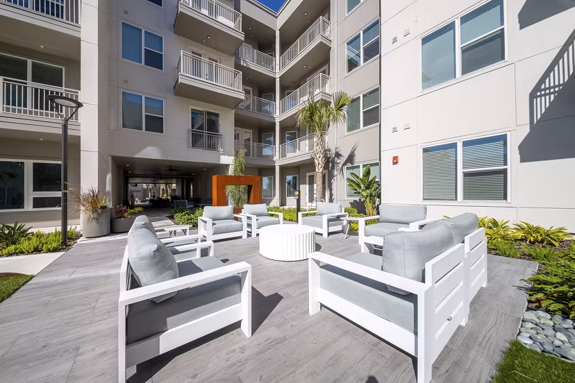 Scenic patio with cozy seating at Novel Nona Apartments, perfect for relaxation and social gatherings
