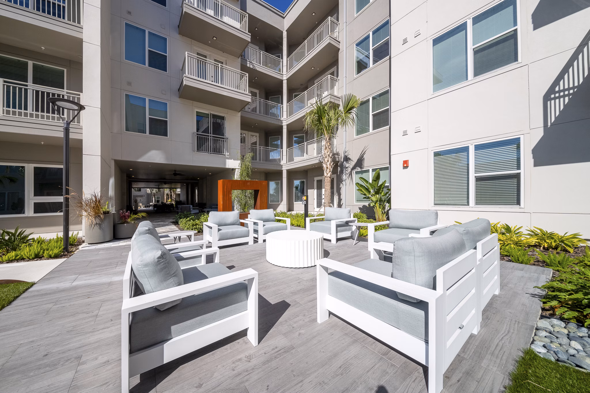 Scenic patio with cozy seating at Novel Nona Apartments, perfect for relaxation and social gatherings