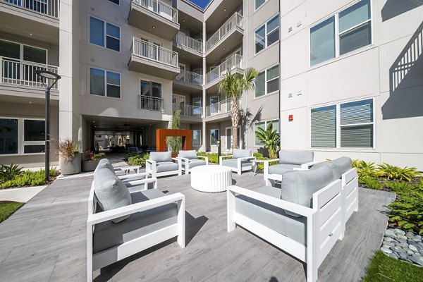 Scenic patio with cozy seating at Novel Nona Apartments, perfect for relaxation and social gatherings