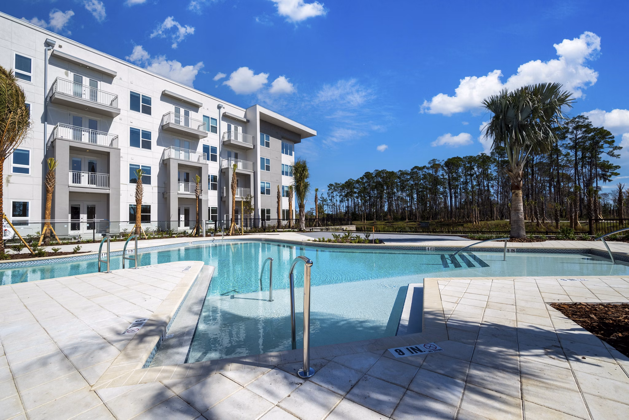 Luxurious pool area with lounge chairs at Novel Nona Apartments, Florida's premier luxury living destination Perfect for relaxation and recreation