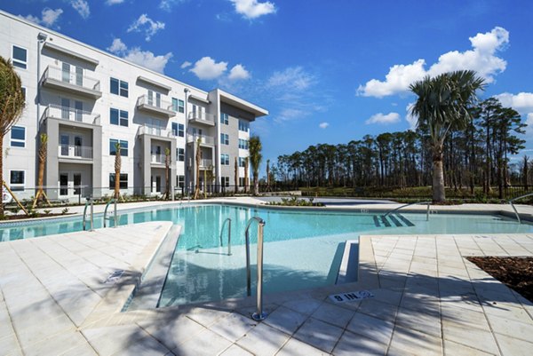 Luxurious pool area with lounge chairs at Novel Nona Apartments, Florida's premier luxury living destination Perfect for relaxation and recreation