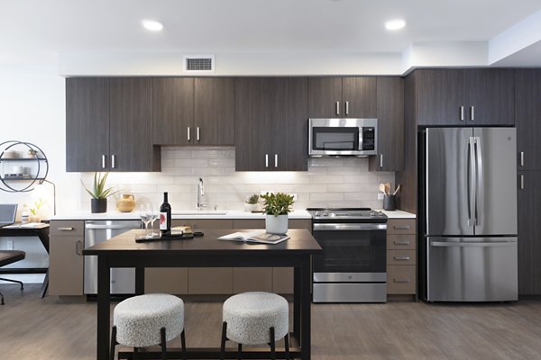 Modern kitchen with sleek countertops and stainless steel appliances in Lantana at Milpitas Station apartments