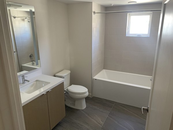 Bathroom featuring modern fixtures and elegant tiling at Lantana Uptown luxury apartments