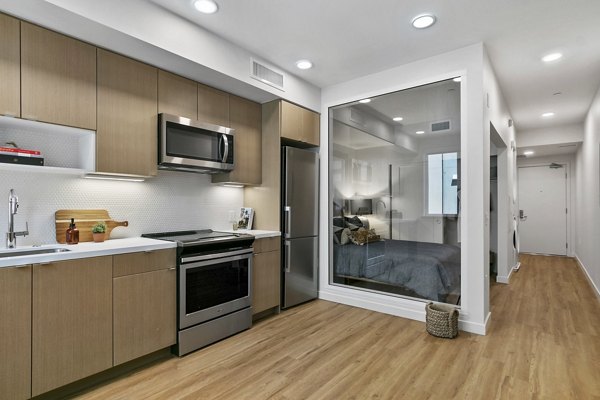 Modern kitchen featuring stainless steel appliances and granite countertops at Lantana Uptown luxury apartments