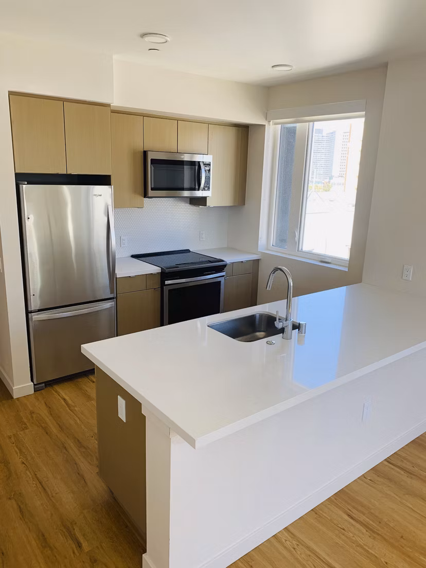 Modern kitchen with stainless steel appliances at Lantana Uptown luxury apartments