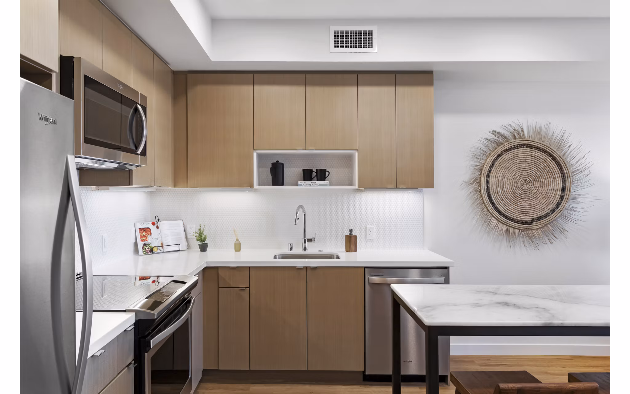 Lantana Uptown: Modern kitchen with stainless steel appliances and granite countertops in luxury apartments