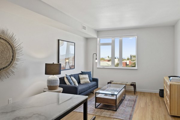 Elegant living room with contemporary decor and abundant natural light at Lantana Uptown luxury apartments