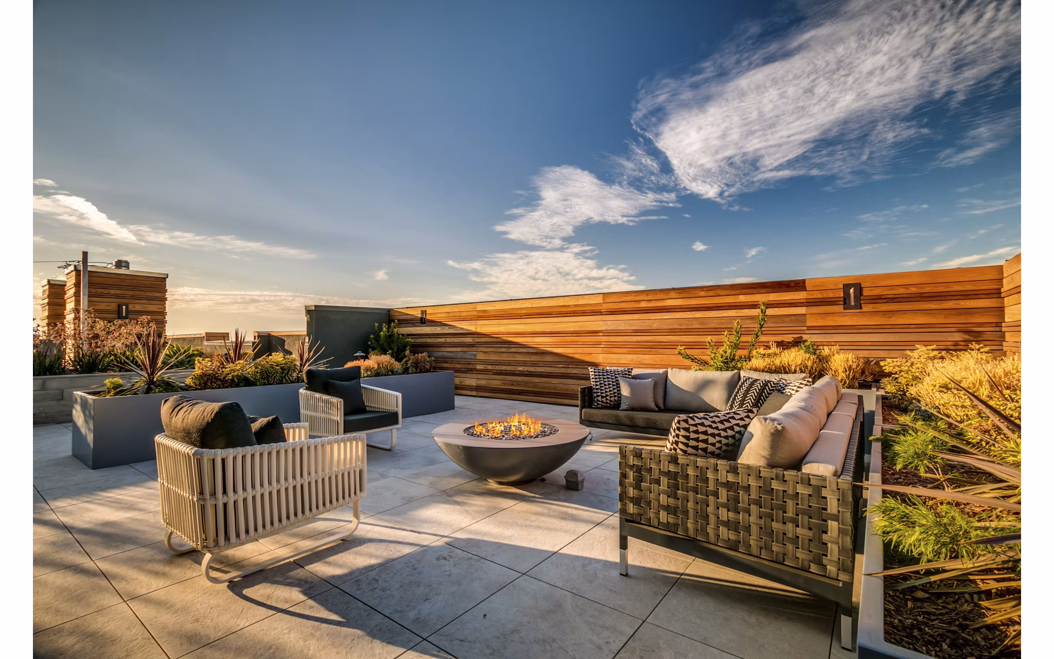 Patio with modern seating and lush greenery at Lantana Uptown luxury apartments