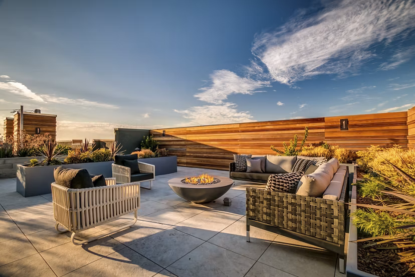 Patio with modern seating and lush greenery at Lantana Uptown luxury apartments