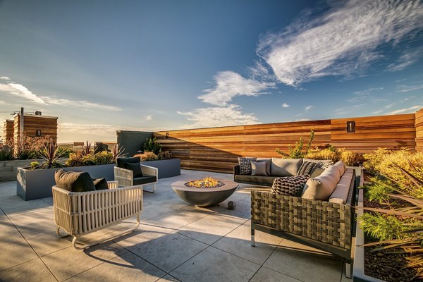 Patio with modern seating and lush greenery at Lantana Uptown luxury apartments