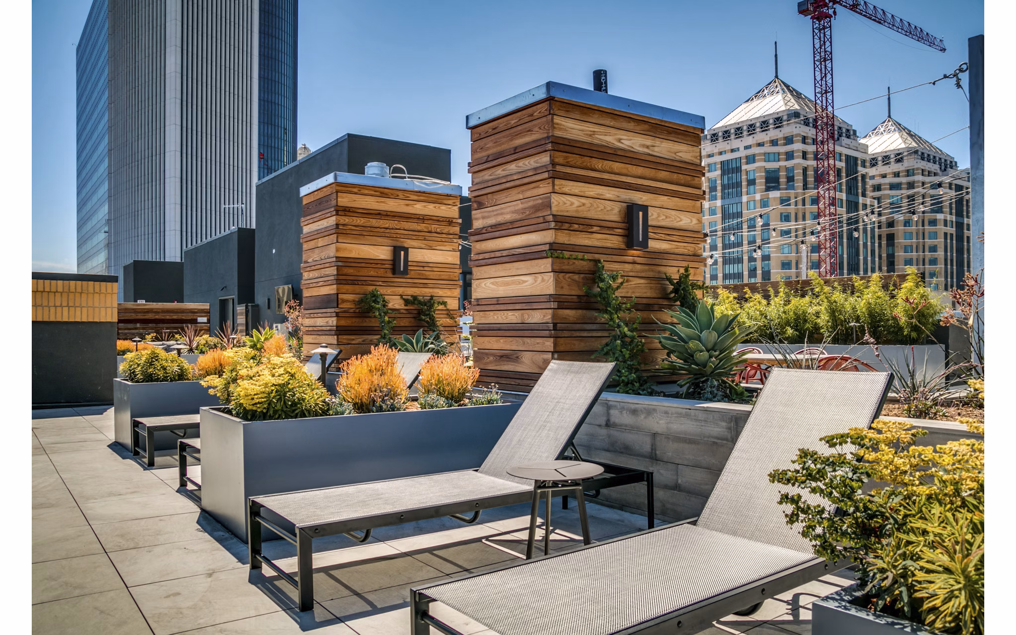 Patio with comfortable seating and lush greenery at Lantana Uptown luxury apartments
