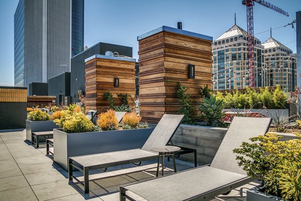 Patio with comfortable seating and lush greenery at Lantana Uptown luxury apartments