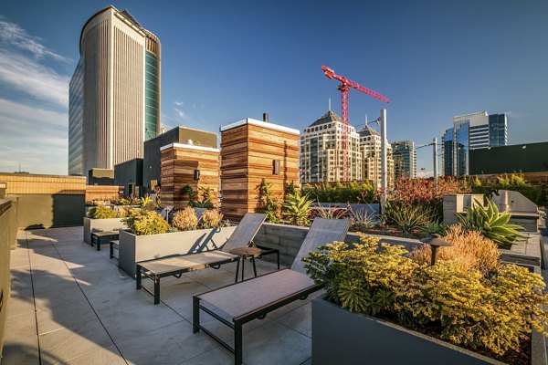 Patio with modern seating and lush greenery at Lantana Uptown luxury apartments in a vibrant urban setting