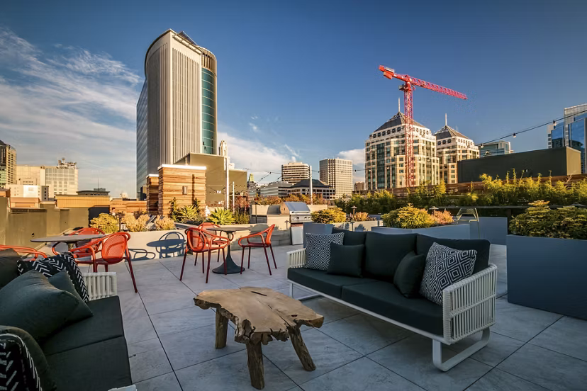 Patio featuring modern outdoor seating and lush greenery at Lantana Uptown luxury apartments