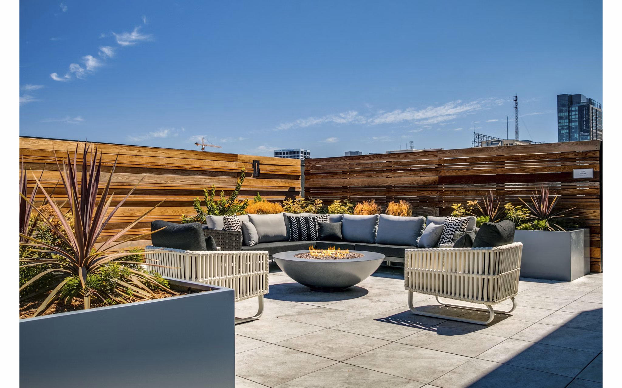 Lantana Uptown: Stylish patio with modern seating and greenery in luxury urban setting