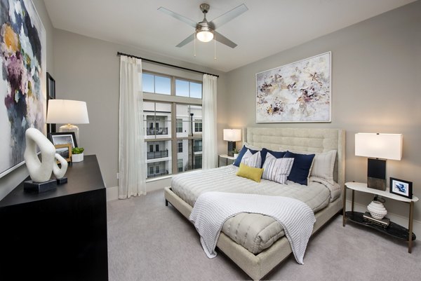 Modern bedroom with natural lighting at The Lights at Northwinds Apartments