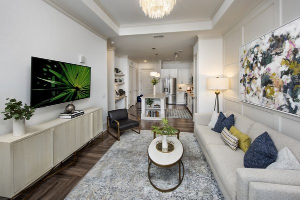 Living room with contemporary furnishings and large windows at The Lights at Northwinds Apartments