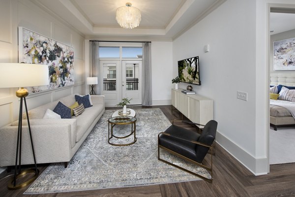 Spacious living room with modern furnishings at The Lights at Northwinds Apartments, featuring luxury amenities for a comfortable lifestyle