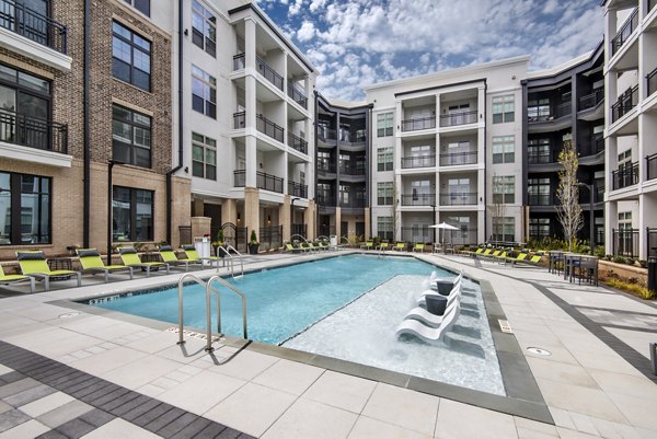 The Lights at Northwinds: Modern pool surrounded by lush landscaping, offering relaxation and recreation for residents
