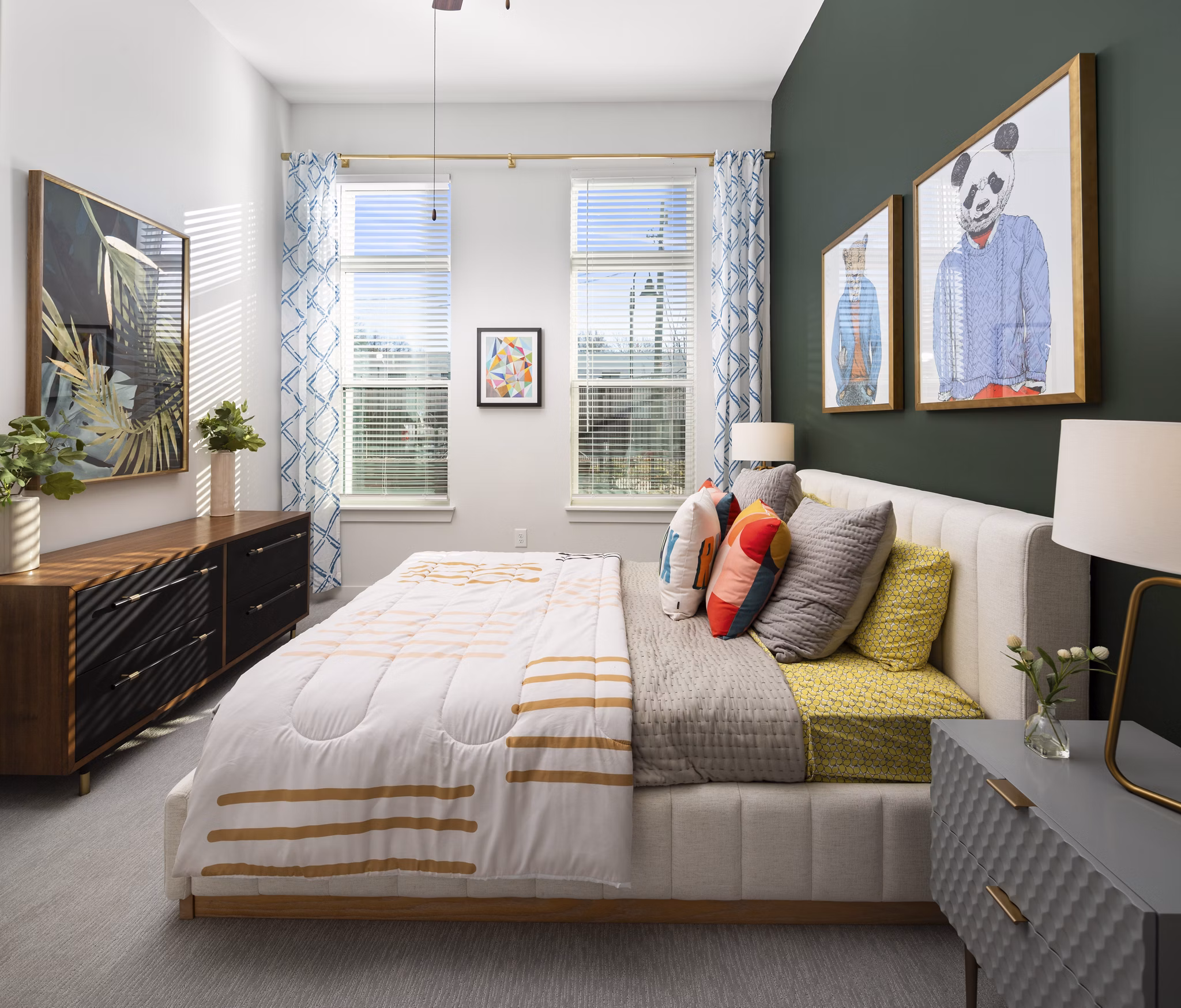 Elegant bedroom with modern decor at The Lowery Apartments, featuring plush bedding and stylish lighting for a luxurious living experience