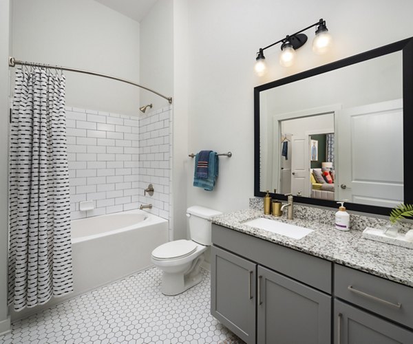 Modern bathroom with marble countertops at The Lowery Apartments