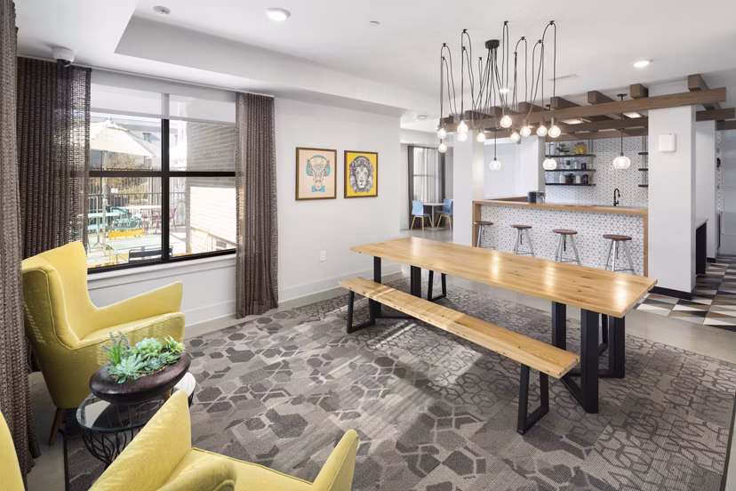Clubhouse with modern design elements at The Lowery Apartments, featuring open spaces and cozy seating areas for residents