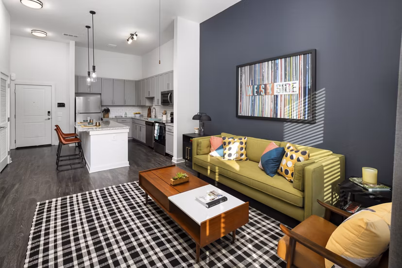 Living room with modern decor and large windows at The Lowery Apartments