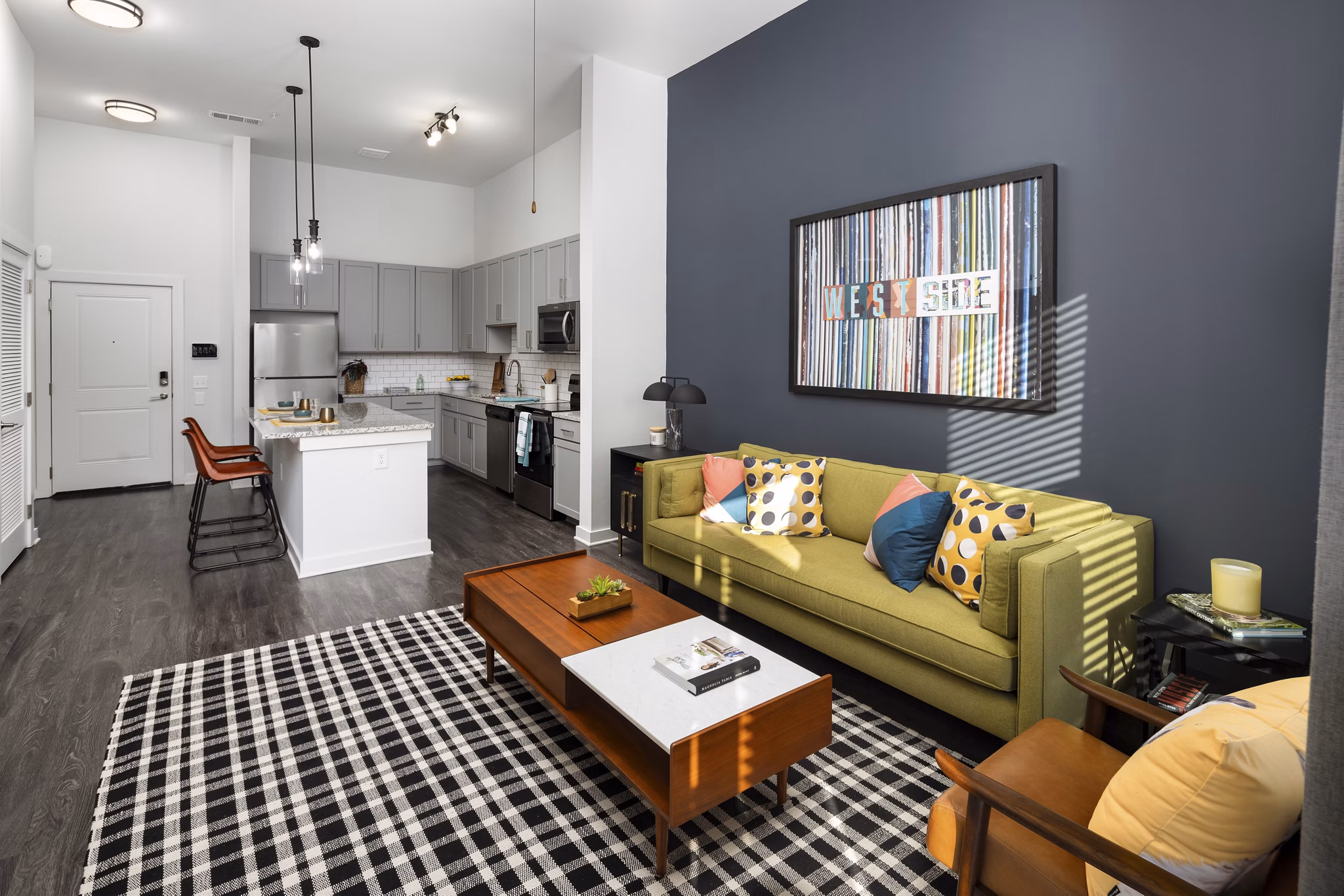 Living room with modern decor and large windows at The Lowery Apartments