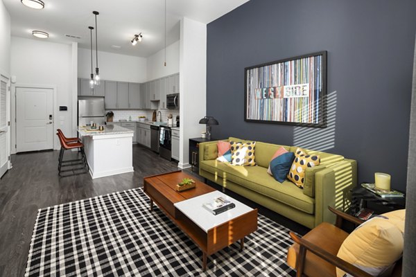 Living room with modern decor and large windows at The Lowery Apartments