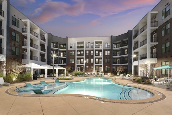 Elegant poolside at The Lowery Apartments offering a relaxing environment with luxury seating options and clear blue water