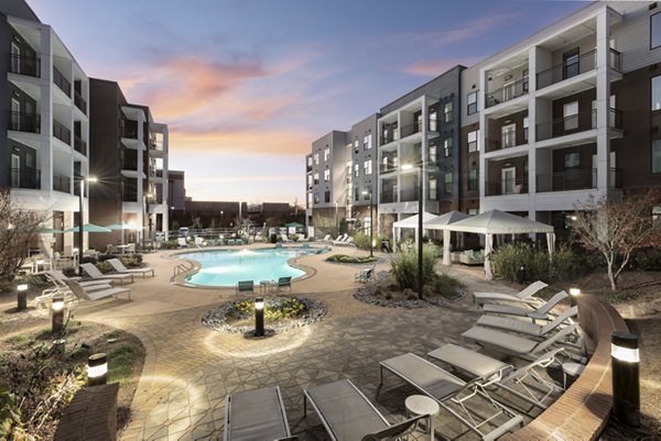 Chic resort-style pool surrounded by lush landscaping at The Lowery Apartments