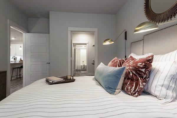 Cozy bedroom with modern decor at Luxe at Mile High luxury apartments in Denver