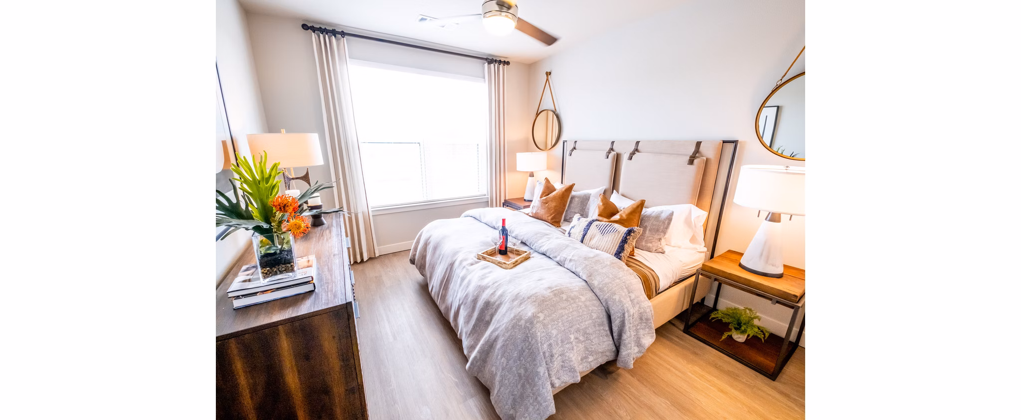 Bedroom featuring contemporary design and city views at Luxe at Mile High luxury apartments