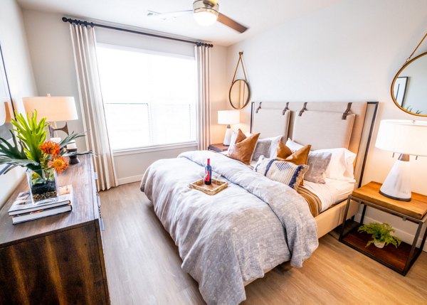 Bedroom featuring contemporary design and city views at Luxe at Mile High luxury apartments
