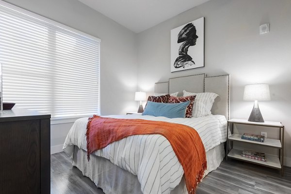 Elegant bedroom with city views at Luxe at Mile High luxury apartments