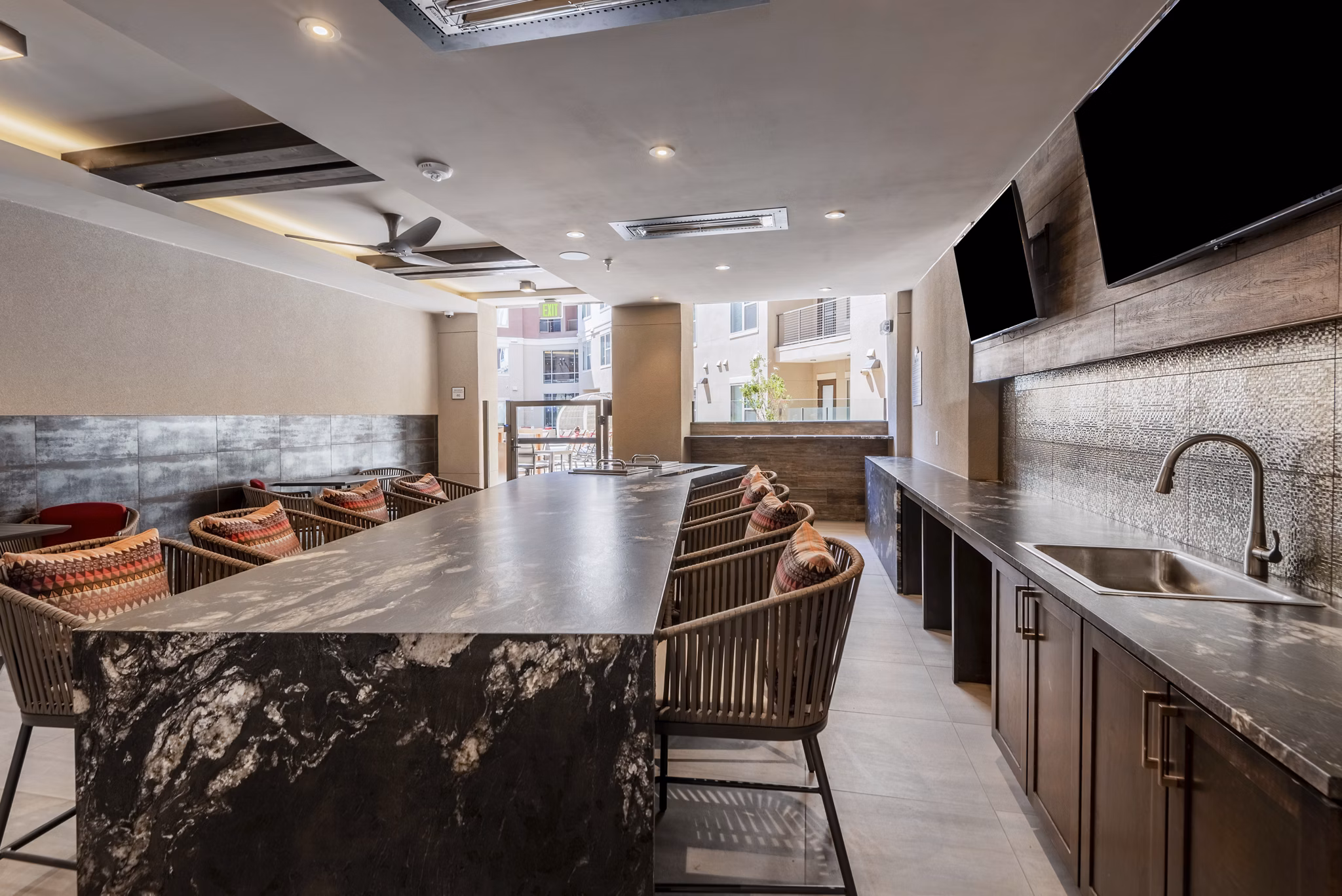 Dining area featuring elegant lighting and modern decor in Luxe at Mile High apartments